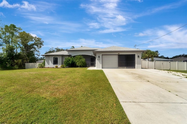 single story home featuring a garage and a front lawn