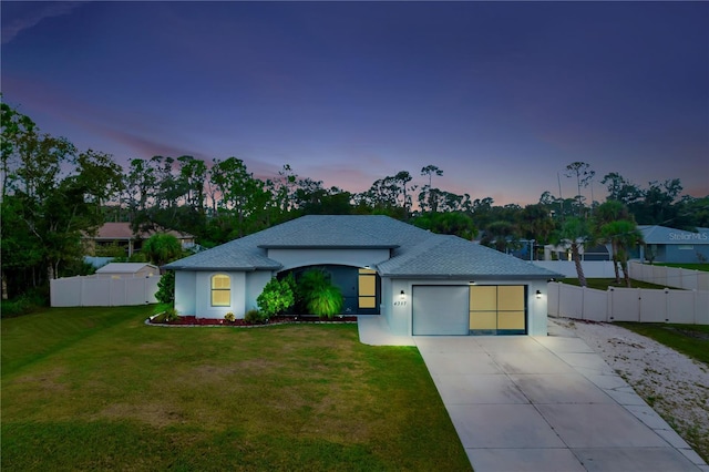 view of front of house with a yard and a garage