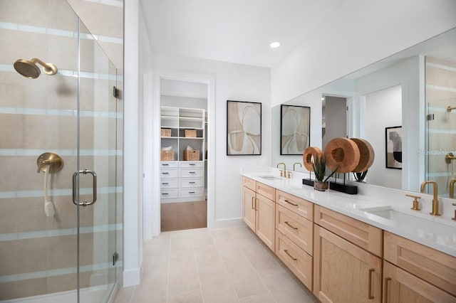 bathroom with vanity, tile patterned floors, and a shower with shower door