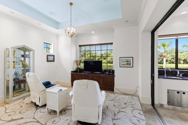 tiled office space with a chandelier, a tray ceiling, ornamental molding, and sink