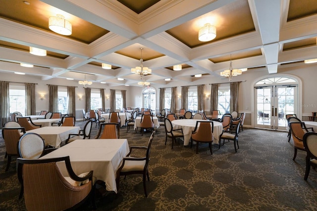 carpeted dining room featuring french doors, coffered ceiling, an inviting chandelier, crown molding, and plenty of natural light