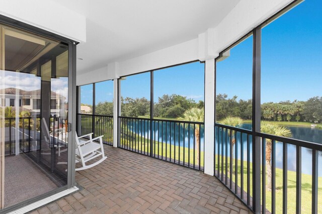 unfurnished sunroom with a water view and a wealth of natural light