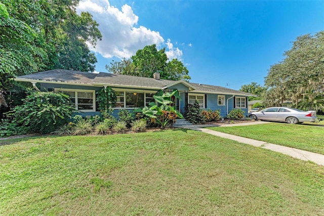 ranch-style home with a front lawn