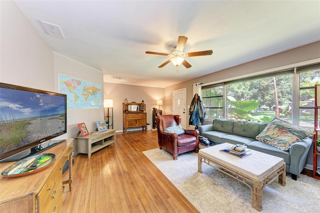 living room with ceiling fan and hardwood / wood-style flooring