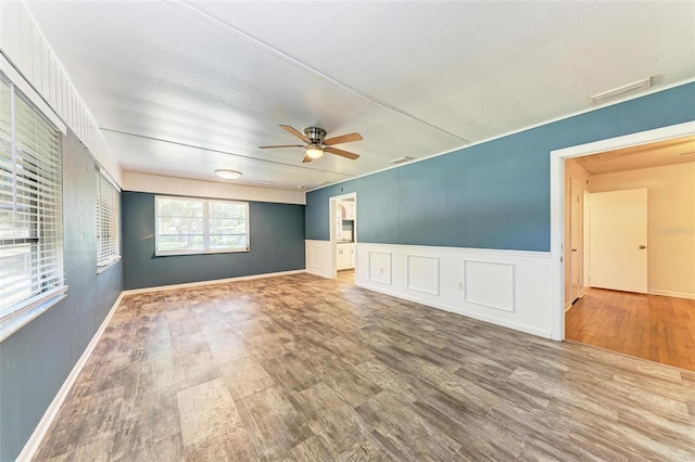 empty room featuring ceiling fan and hardwood / wood-style flooring