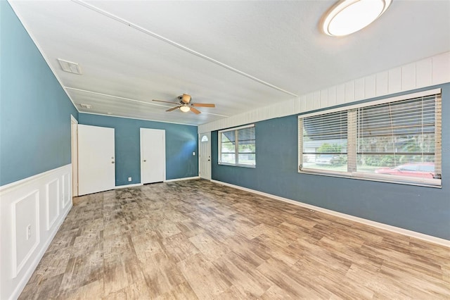 spare room with light wood-type flooring and ceiling fan