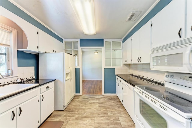 kitchen featuring light hardwood / wood-style floors, sink, white cabinetry, white appliances, and backsplash