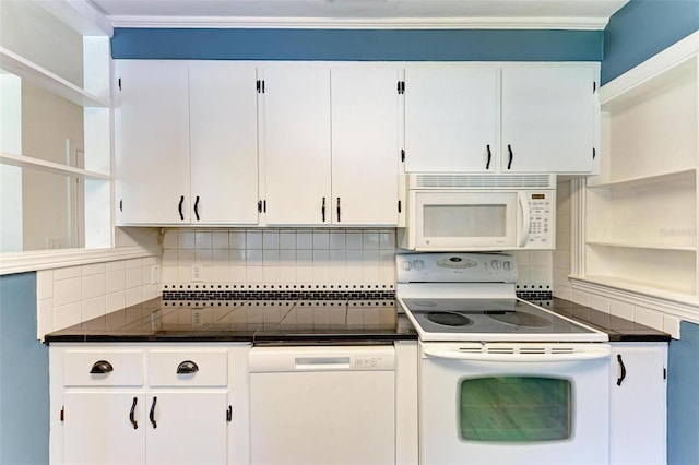 kitchen with white appliances, tasteful backsplash, and white cabinets