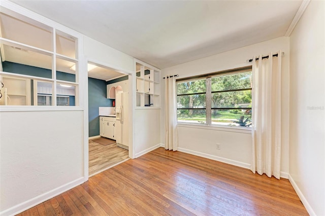 empty room with light hardwood / wood-style flooring