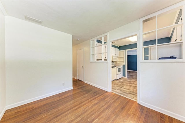 unfurnished living room with hardwood / wood-style floors