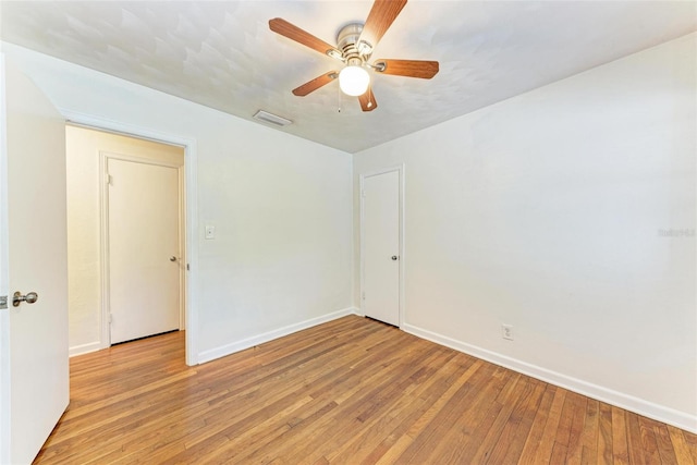 unfurnished room featuring light wood-type flooring and ceiling fan