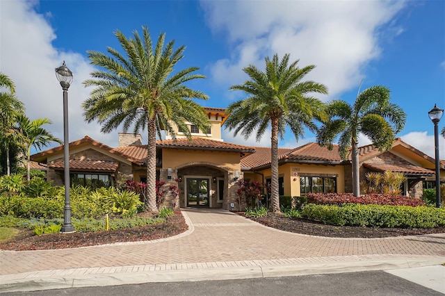 mediterranean / spanish home featuring french doors