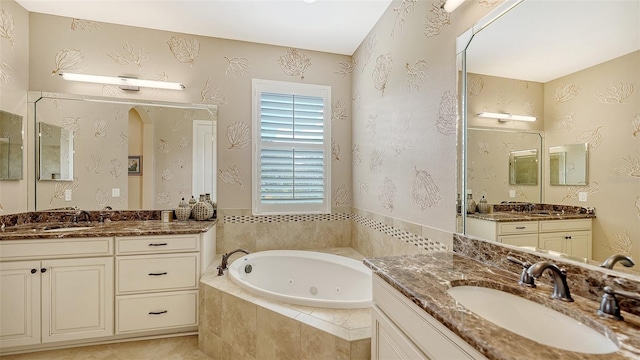 bathroom with tiled bath and vanity