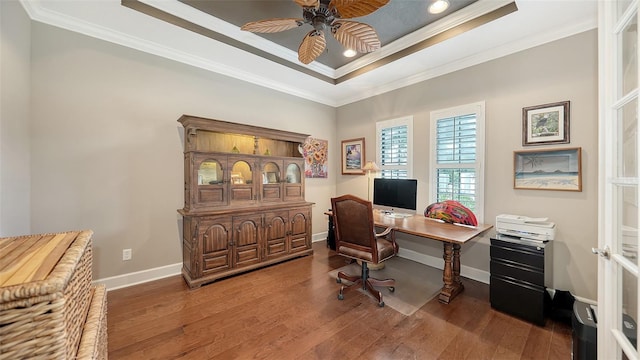 office featuring hardwood / wood-style flooring, ceiling fan, crown molding, and a tray ceiling