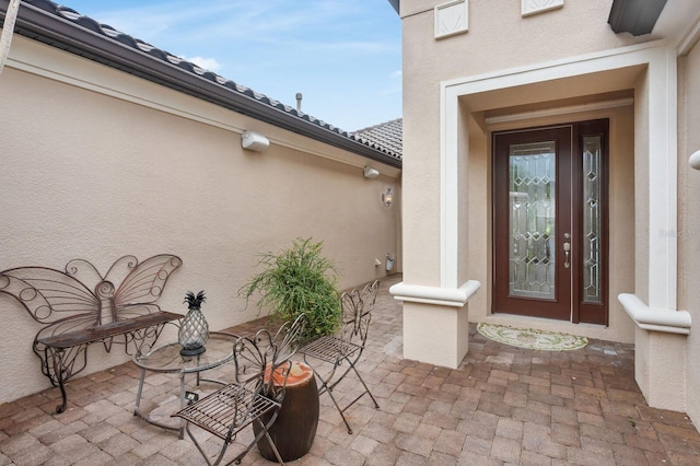 12663 Fontana Loop, Bradenton, FL 34211 - view of exterior entry with stucco siding and a patio area