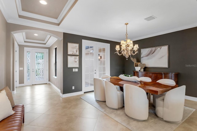 12663 Fontana Loop, Bradenton, FL 34211 - dining space with french doors, arched walkways, ornamental molding, a tray ceiling, and a chandelier