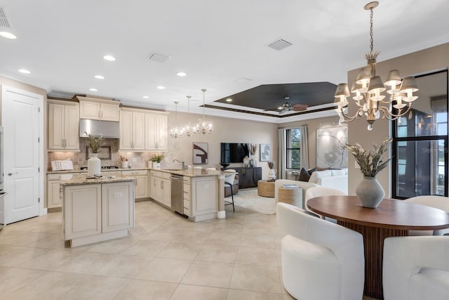 12663 Fontana Loop, Bradenton, FL 34211 - kitchen featuring open floor plan, a chandelier, dishwasher, cream cabinets, and decorative backsplash