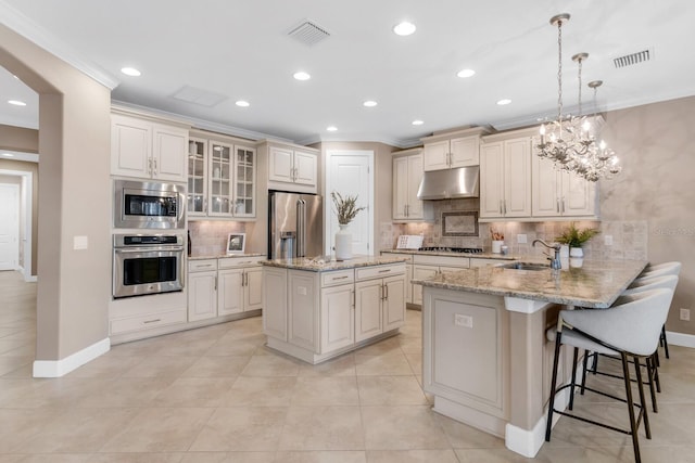 12663 Fontana Loop, Bradenton, FL 34211 - kitchen with appliances with stainless steel finishes, crown molding, under cabinet range hood, a peninsula, and tasteful backsplash