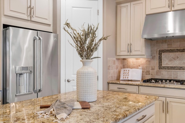 12663 Fontana Loop, Bradenton, FL 34211 - kitchen with stainless steel appliances, under cabinet range hood, backsplash, and light stone countertops