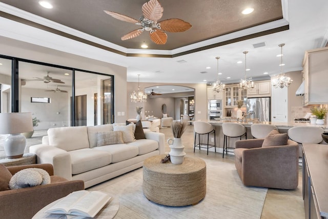 12663 Fontana Loop, Bradenton, FL 34211 - living room with a chandelier, a tray ceiling, recessed lighting, ceiling fan, and ornamental molding