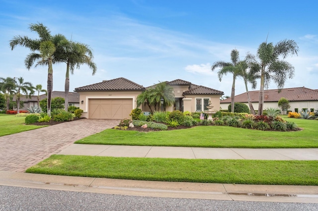12663 Fontana Loop, Bradenton, FL 34211 - mediterranean / spanish house featuring stucco siding, a garage, driveway, a front yard, and a tiled roof
