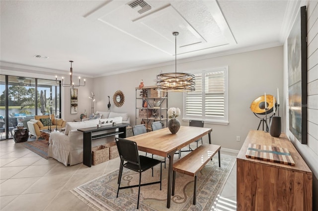 dining room featuring a wealth of natural light, light tile patterned flooring, a notable chandelier, and ornamental molding