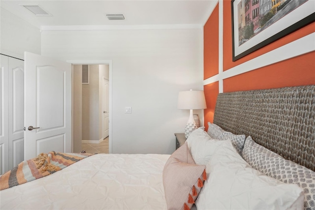 bedroom with a closet and crown molding