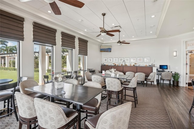 dining space featuring crown molding, ceiling fan, and wood-type flooring