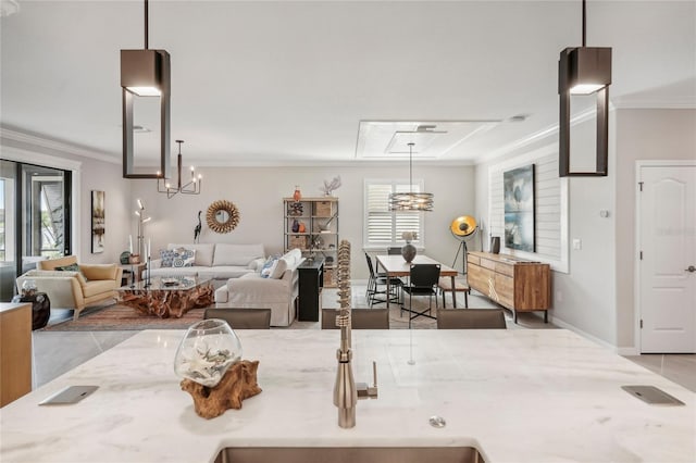 kitchen featuring a chandelier, light stone counters, hanging light fixtures, and ornamental molding