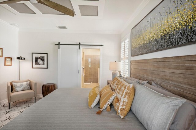 bedroom with ensuite bathroom, a barn door, ornamental molding, and ceiling fan