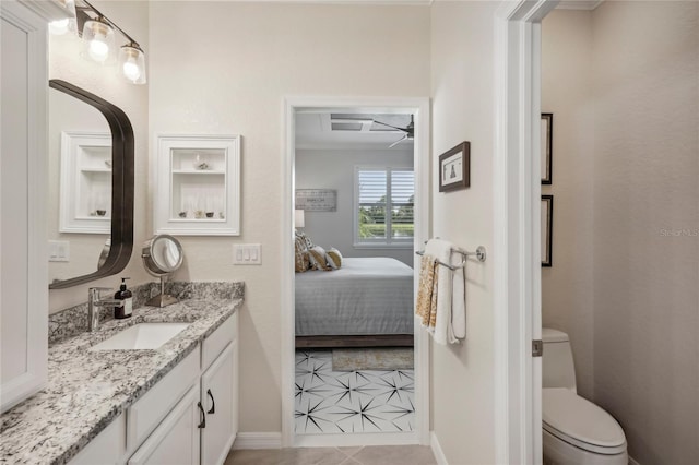 bathroom featuring tile patterned floors, vanity, and toilet