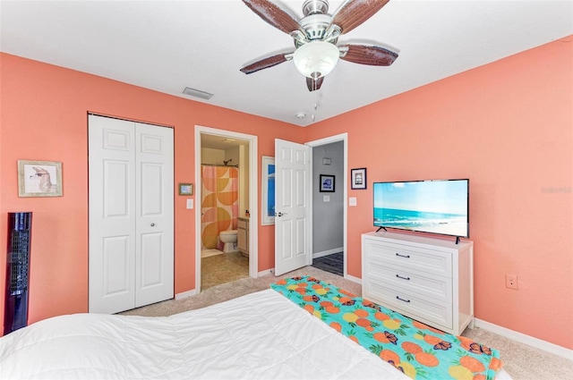 bedroom featuring visible vents, baseboards, a closet, ensuite bathroom, and light carpet