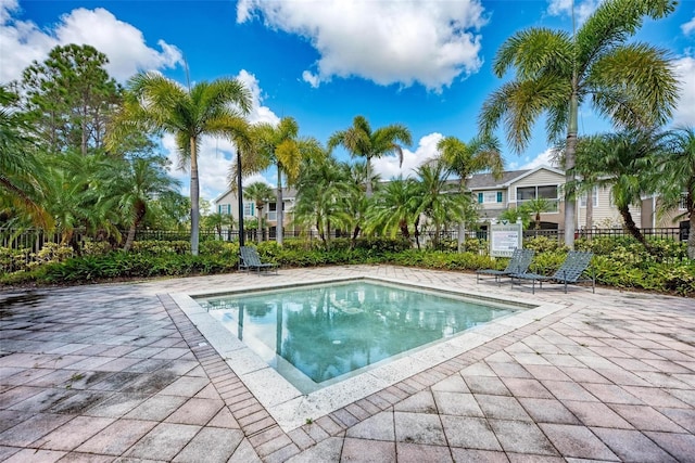 view of swimming pool featuring a fenced in pool, a patio, and fence
