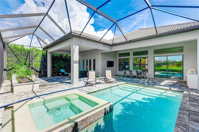 view of pool with glass enclosure, an in ground hot tub, and a patio area