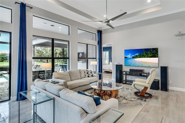 living room featuring ceiling fan, plenty of natural light, and ornamental molding