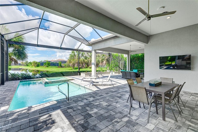 view of pool with glass enclosure, a water view, an in ground hot tub, ceiling fan, and a patio area