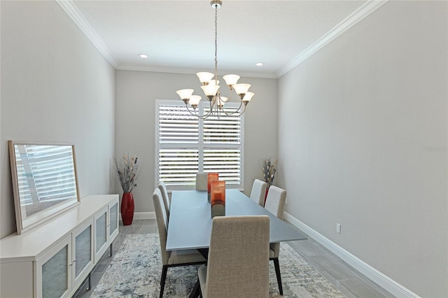 dining area with ornamental molding and a chandelier