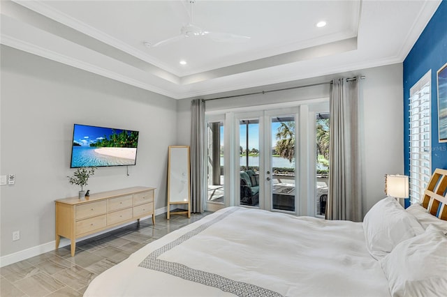 bedroom featuring a tray ceiling, access to exterior, ornamental molding, ceiling fan, and french doors