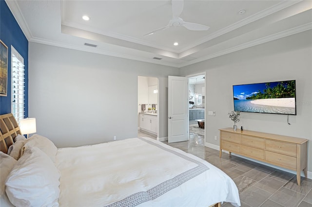 bedroom with ceiling fan, a raised ceiling, ensuite bath, and crown molding