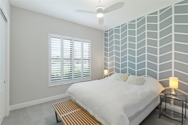 carpeted bedroom with ceiling fan and a closet