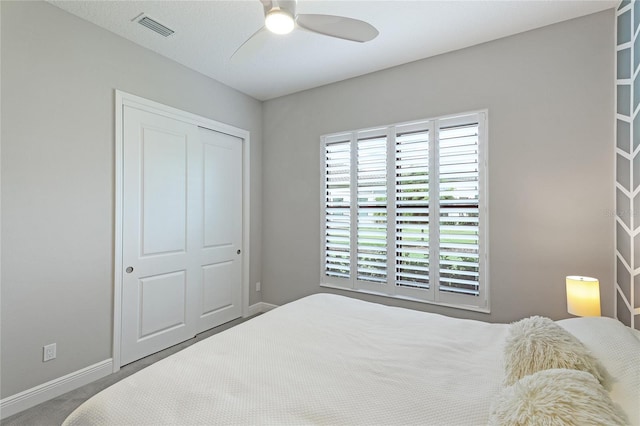 bedroom featuring a closet, ceiling fan, and carpet flooring