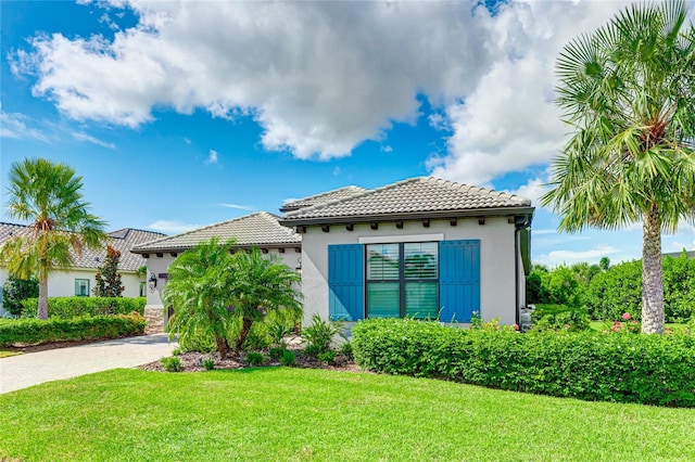 view of front of property featuring a garage and a front lawn