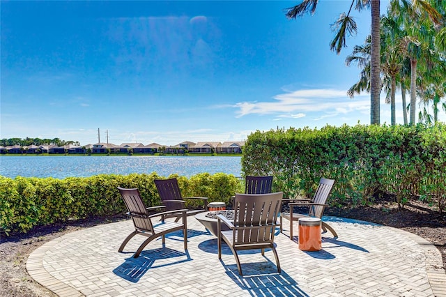 view of patio with a water view and an outdoor fire pit