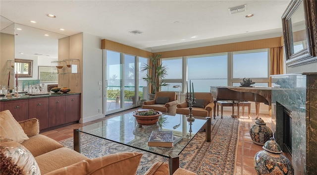 tiled living room featuring a high end fireplace