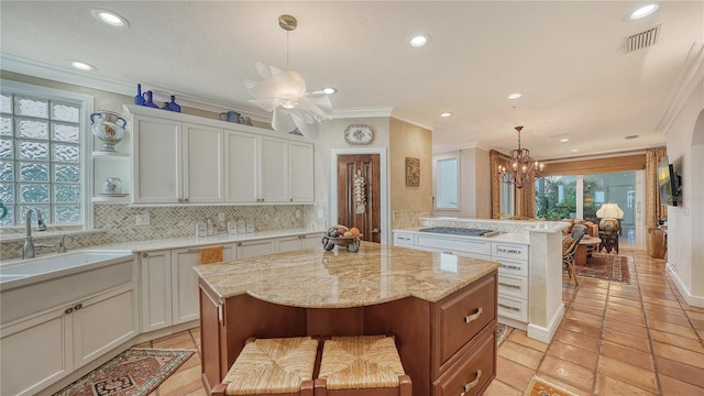 kitchen featuring a kitchen island, pendant lighting, and a healthy amount of sunlight