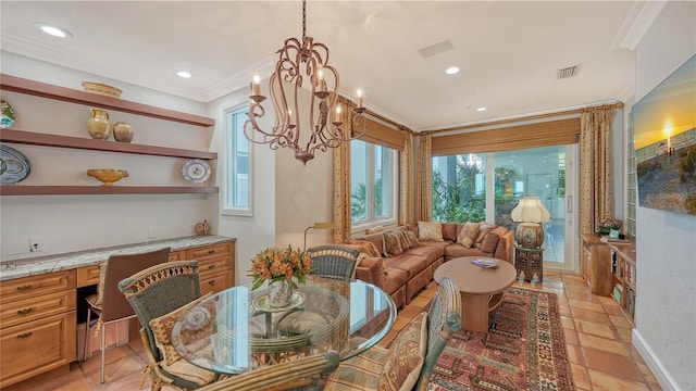 dining area featuring built in desk, a chandelier, and crown molding