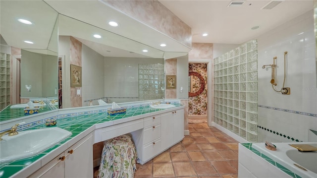 bathroom with shower with separate bathtub, vanity, and tile patterned floors