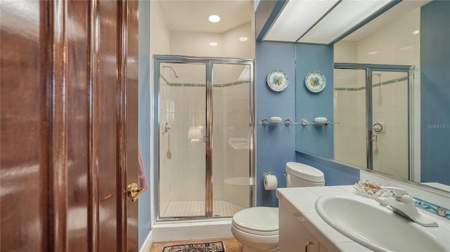 bathroom with tile patterned flooring, vanity, toilet, and a shower with door