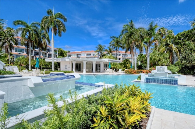 view of swimming pool with a hot tub