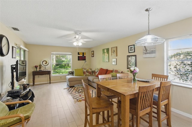 5071 Village Gardens Dr Unit 5, Sarasota, FL 34234 - dining space featuring a ceiling fan, light wood-type flooring, and a textured ceiling